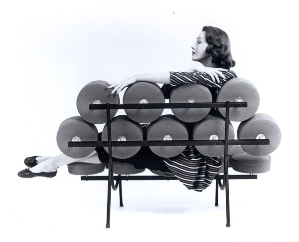 black and white photo of woman sitting on modern couch