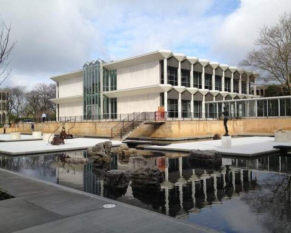 Building exterior with sculptures in reflecting pond