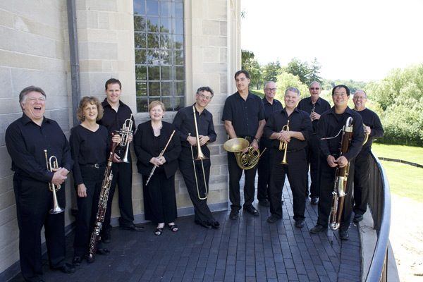 Detroit Chamber Winds players smile at camera