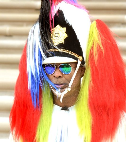 man in sunglasses wearing colorful furs