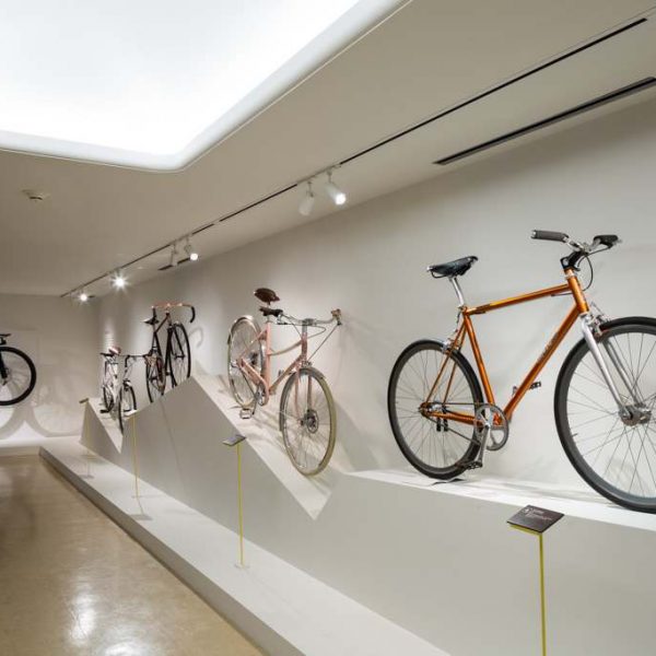 colorful bikes on white display platform