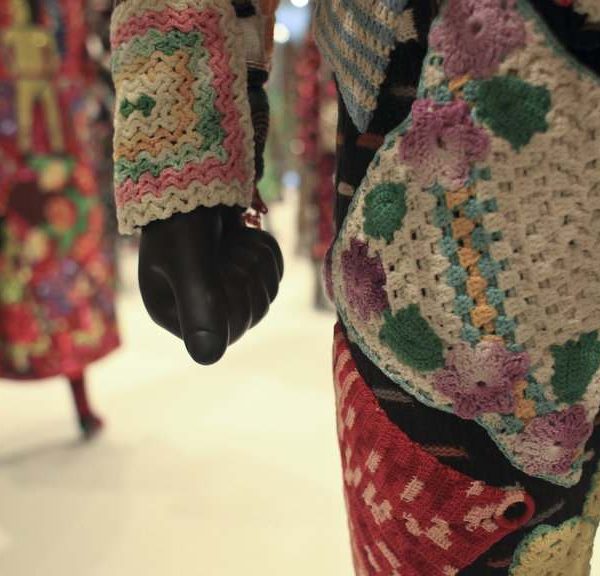 mannequin hand with colorful, woven floral clothing