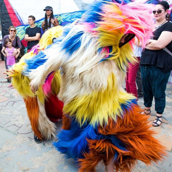 dancing figures dressed in colorful furs