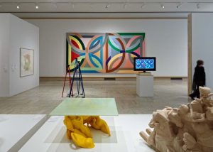 exhibit hall with colorful geometric painting and yellow table