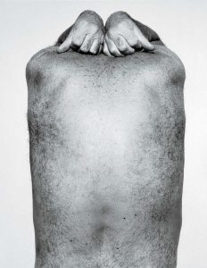 photo of the back of male torso with two hands