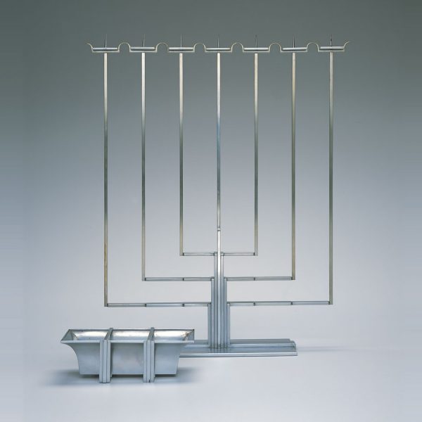 silver metal candelabra against gray background