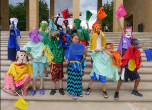 students pose with custom masks and flags