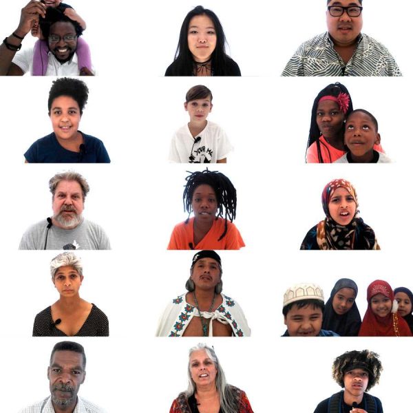 vertical image of twenty people looking at camera against white background