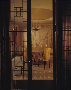 dining table and chairs behind glass doors