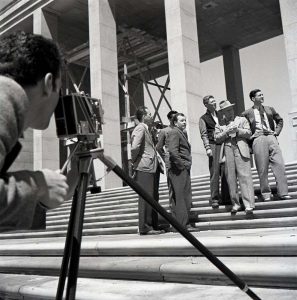 black and white photo of man taking group picture