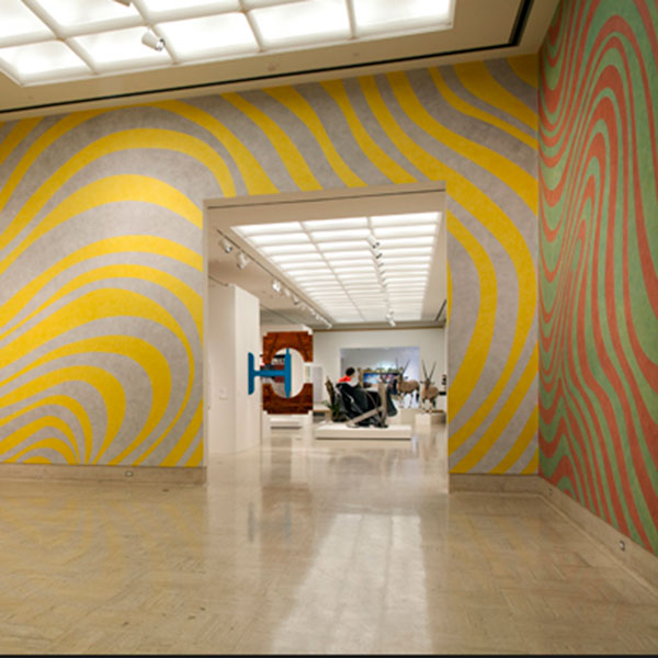 empty exhibit hall with red and yellow swirls on walls