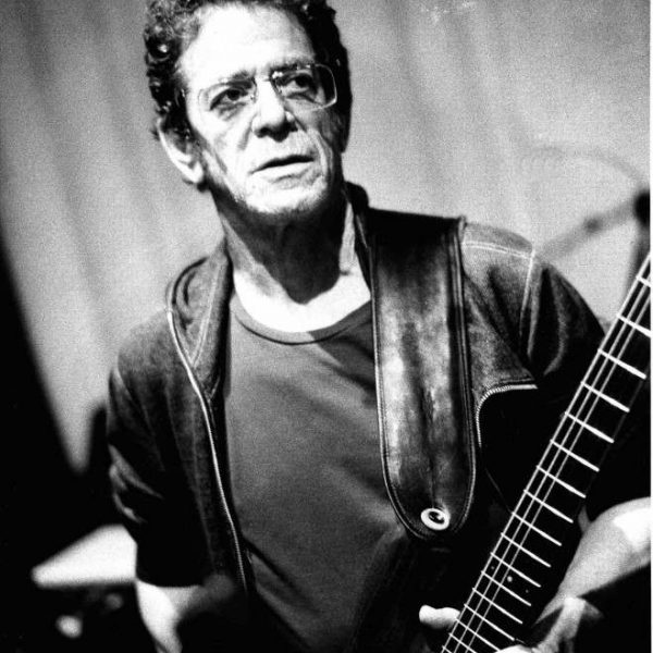 black and white photo of Lou Reed with guitar