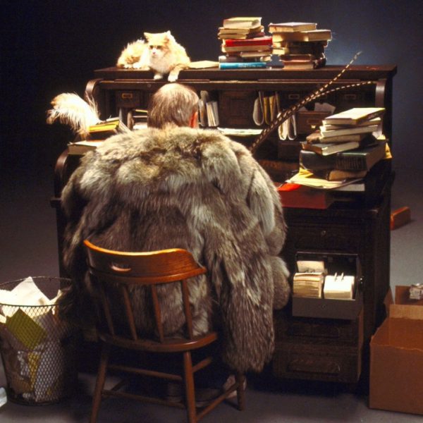 photo of man in fur coat at writing desk