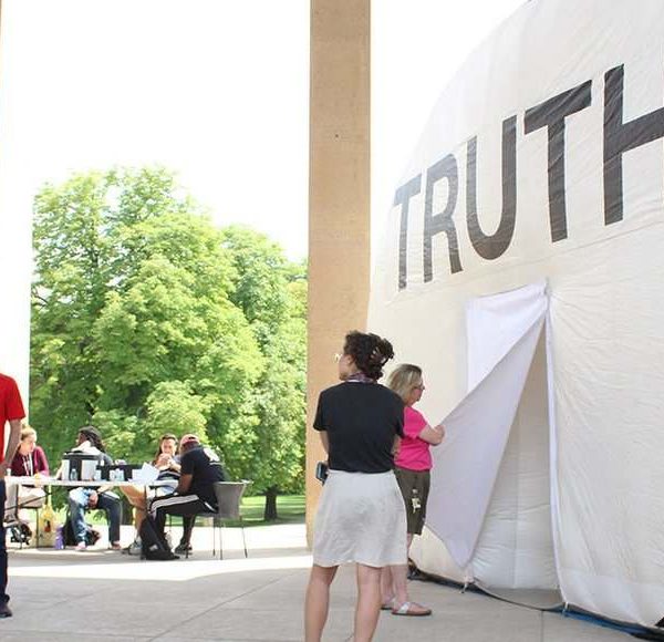 woman opening doorway to truth inflatable speech bubble