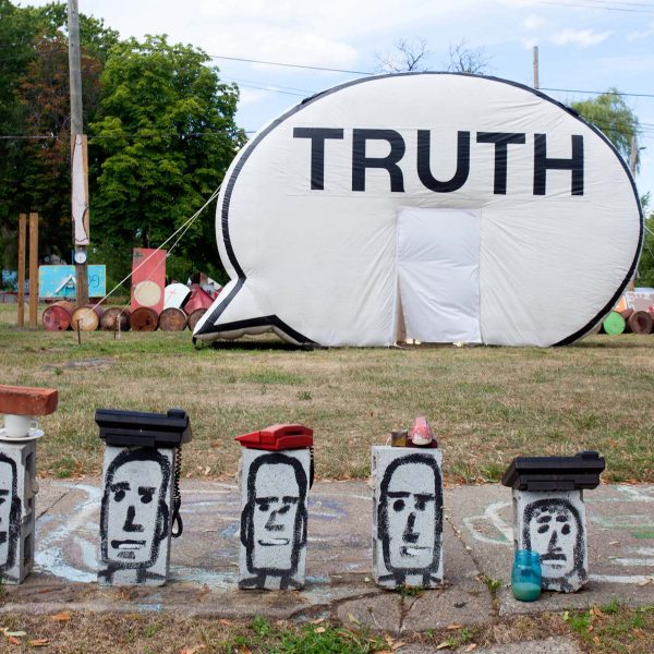 Truth Booth with heads painted on cinder blocks