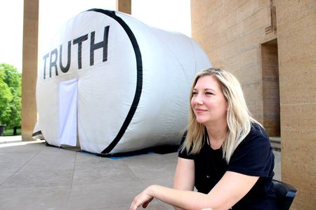 L. Mott sitting in front of Truth Booth