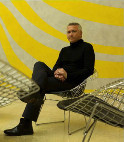 Chris Scoates portrait against yellow striped background