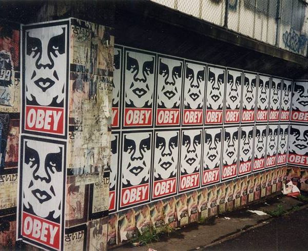 punk Obey signs on outdoor wall