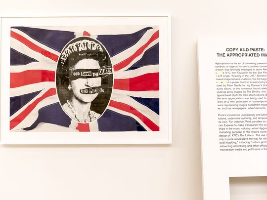 Portrait of the British queen over British flag with quote across her face