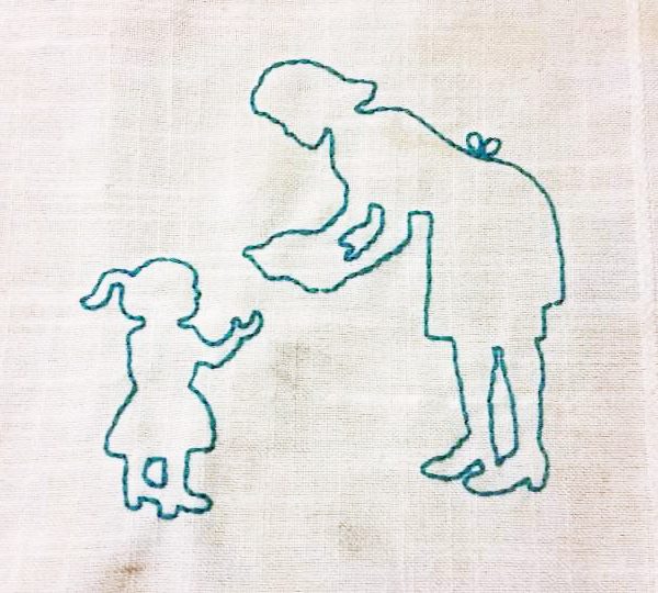 silhouette of woman and child stitched into fabric