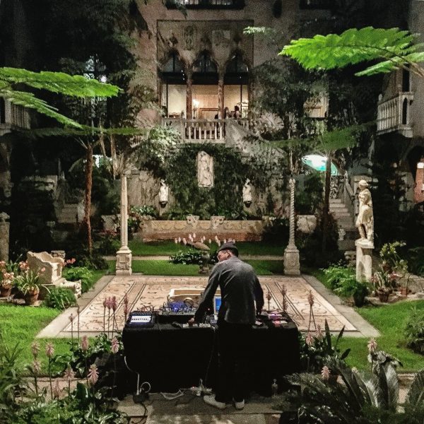 Man standing at table in the middle of a garden