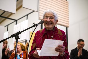 Ruth Adler Schnee speaking into a microphone