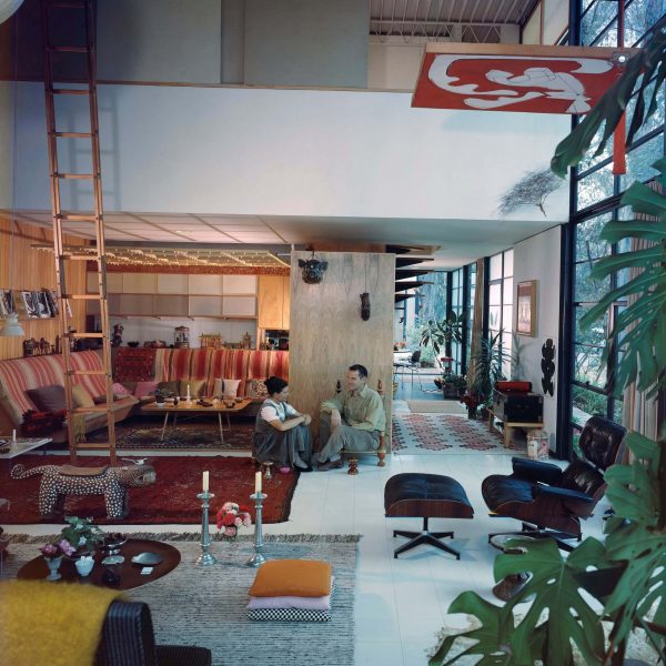 Wide view of Ray (left) and Charles (right) sitting in their modern Case Study House.