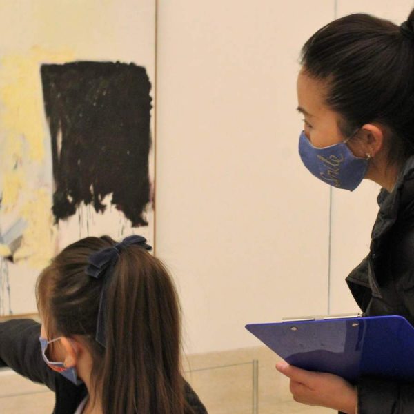 Mom and daughter in winter attire examine large abstract painting at Cranbrook Art Museum